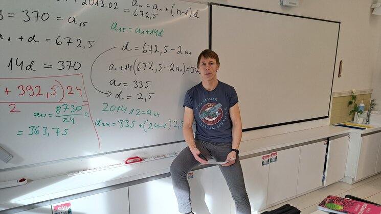 Math teacher infront of the whiteboard.